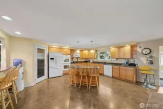 Kitchen on the upper level features an island bar and also a 2nd bar eating area at the pass through to the dining room. There's even space for an additional small table if you desire.