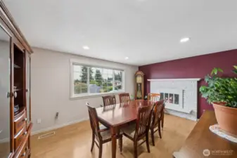 Dining room features space for a large table and seating, plus the china hutch. Fireplace mantle graces this room to make it naturally beautiful. Plenty of natural light and views of the Sound. (NOTE: fireplace is currently not operational-photographer added the look of a fire. It is possible to add an insert should the buyer choose)