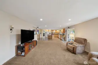 View of the family room back to the kitchen and dining room. Area to the right is a mud room/extra finished room that could be a small office space too.