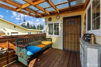 Covered back deck leads to the backyard and detached garage.