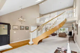 The front of the great room offers views of the courtyard. Note the hardwood floors gracing the foyer.  New carpet has just been completed in the Great Room & entire upper level of the home.