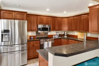 The inviting kitchen featuring stainless appliances.