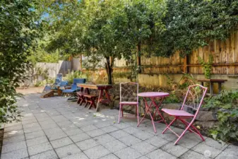 Communal space with stone patio and fruit trees