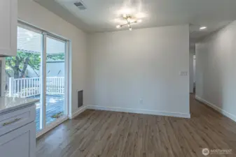 Dining area with sliders to the deck & built in dog door.