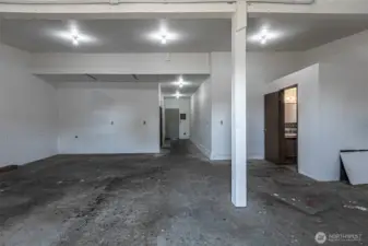 Looking back to shop exterior door, half bath to the right.