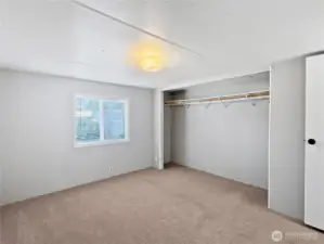 The primary bedroom is located on the opposite side of the other bedrooms, offering extra privacy.