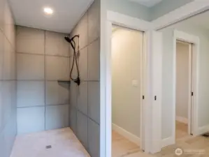 Walk-in shower with porcelain tiles.