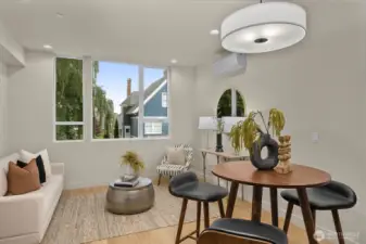 The dining space is wrapped in windows and highlighted by sleek lighting, offering a sunny setting for every meal.