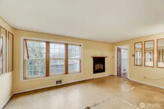 Living room with gas fireplace. Solid fir flooring underneath the vinyl.