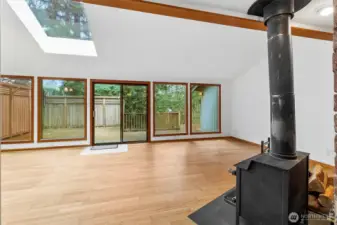 Walking into the Vaulted Great Room with ample light from skylights and wall of windows.
