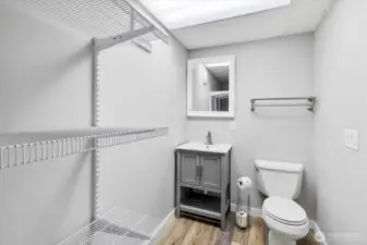 Basement half bathroom with extra storage.
