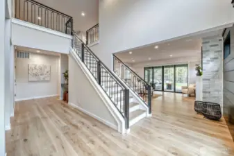 Front foyer area looking into living room/garage hallway/upstairs loft area