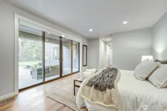 Main floor 2nd Primary with private patio set back from the rest of the backyard.