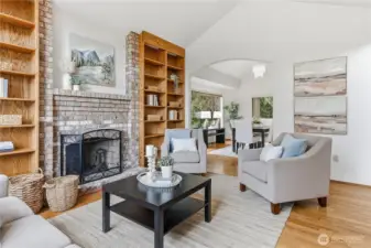 The wood burning fireplace creates a lovely space to relax or entertain. The dining room is in the background.