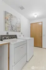 Downstairs laundry/mud room connecting to the garage.