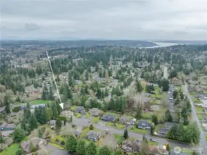 Aerial view looking southeast, featuring Lake Washington in the upper right and the Cascade Mountains in the background to the left.