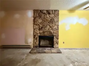 Cool statement fireplace would be beautiful with a honey-oak flooring and fresh paint.