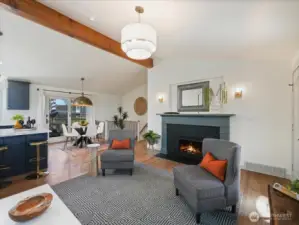 Cozy fireplace with a beautiful mantle, complemented by custom sconces on each side.