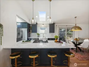 Showcasing Quartz countertops, custom cabinetry, oversized fireclay farmhouse sink, subway tile backsplash, stainless steel appliances including gas range and thoughtfully new statement pendants over kitchen island and added sconce lighting over both windows in the kitchen.