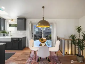 An updated wrought iron railing with a new wood handrail enhances the transition to the lower level.