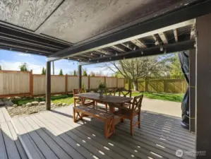 Enjoy year-round entertaining on the covered Trex deck and patio -designed for comfort and effortless outdoor living in every season.