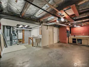 Oversized single car garage with extra room for storage.  Built-in workbench for those projects that need to be done. A convenient free standing sink, and new furnace installed in 2023. Never run out of hot water with your on demand hot water tank.