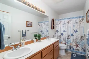 Upstairs full bathroom with new vinyl floors, new elongated toilet with easy close lid, and dual sinks for those busy mornings!