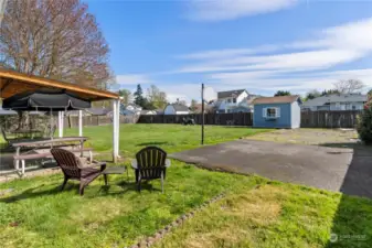 Huge level yard with sports court, shed and plenty of room to park an RV.