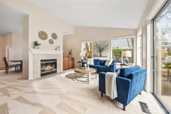 Spacious living room with a natural gas fireplace and abundant natural light.