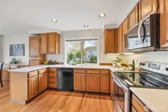 The kitchen features hardwood floors, a new microwave, a newer refrigerator, and more.