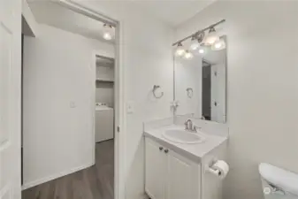 Downstairs half bath. Peep the laundry room with W/D included across the hall