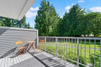 Private balcony deck off of living/dining area over looks shared fenced-in private yard area that is maintained by the HOA
