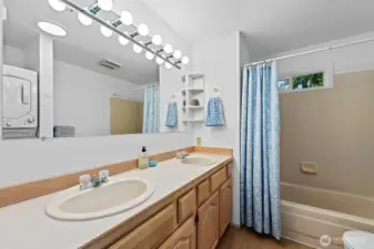 Full bathroom with stacking washer/drier
