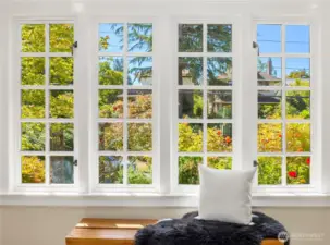 Gorgeous windows frame views of the thriving, rose-filled front garden, bathing the foyer in natural light and ever-changing color.