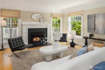 The inviting living room features a beautiful gas log fireplace and windows overlooking the back deck (perfect for al fresco dining!) and garden.