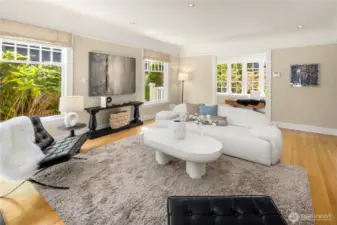 Another view of the living room reveals its generous layout with a graceful flow into the sunlit foyer.