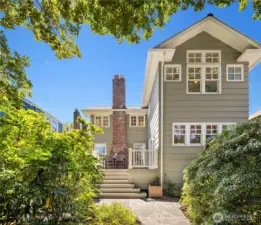 A stunning view of the home from the backyard—elegant, timeless, and framed by lush greenery.