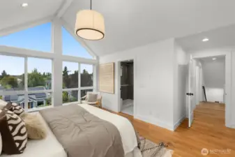 Not your average bedroom oversized glass panes bring the outdoors in and give this space serious wow factor.
