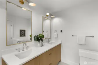 Dual vanities and statement lighting make getting ready feel like self-care.