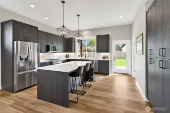 A chef’s dream kitchen with high-end finishes throughout, including Pental Quartz counters, soft-close High Craft cabinets, and a stylish subway tile backsplash. The island with eating bar and storage pantry make both cooking and entertaining a breeze.