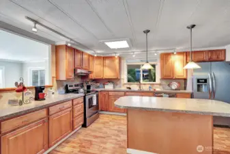 Chefs designed kitchen. Custom designed cabinetry. Added feature of lighting under the upper cabinets for your convenance. Stainless steel appliances. Double sink with custom faucet has garden view from window.  Island has lower storage and custom lighting. Easy care engineered flooring. Family room just steps away.