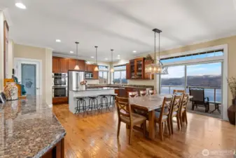 Looking from the living room to the dining area & kitchen, wide open spaces offer a terrific flow. Note the slider to the huge deck, making for easy indoor/outdoor entertaining!