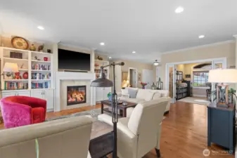 Looking from the living room, the office with its wide glass-paned double door entrance is straight ahead, a powder room and coat closet are to the left of the office, and the main entrance is next to the coat closet.