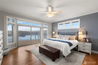 The main floor primary suite has stunning views and a slider to the full-length upper deck.