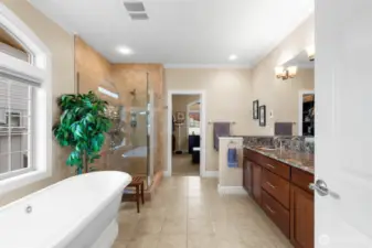 The primary bath features heated ceramic tile floors, a deep tub, a step in shower and dual sinks with granite countertops.
