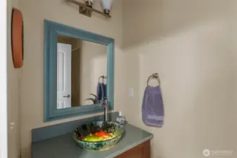 A special feature in the main floor powder room is this lighted coy art sink.