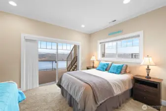 Guest bedroom 2 has a slider leading to the covered deck.