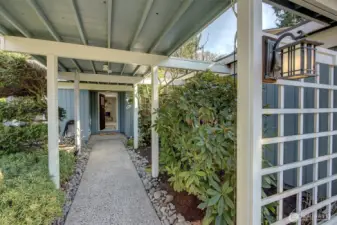 Be greeted with covered entryway by a lush manicured lawn and landscaping.