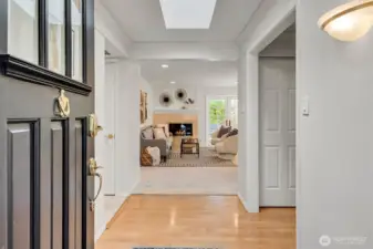 Walk into the bright, airy entrance where natural light streams through the vast skylight above.