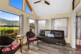 Ceiling fans in the vaulted living room and the bedroom help circulate the heat and air provided by the heat pump.